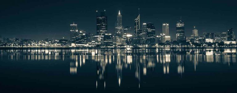 View of the Perth CBD skyline at night. The image is taken from the southern side of the Rive and shows the Perth skyline with many builging lights ob shining out across the River and against the night sky